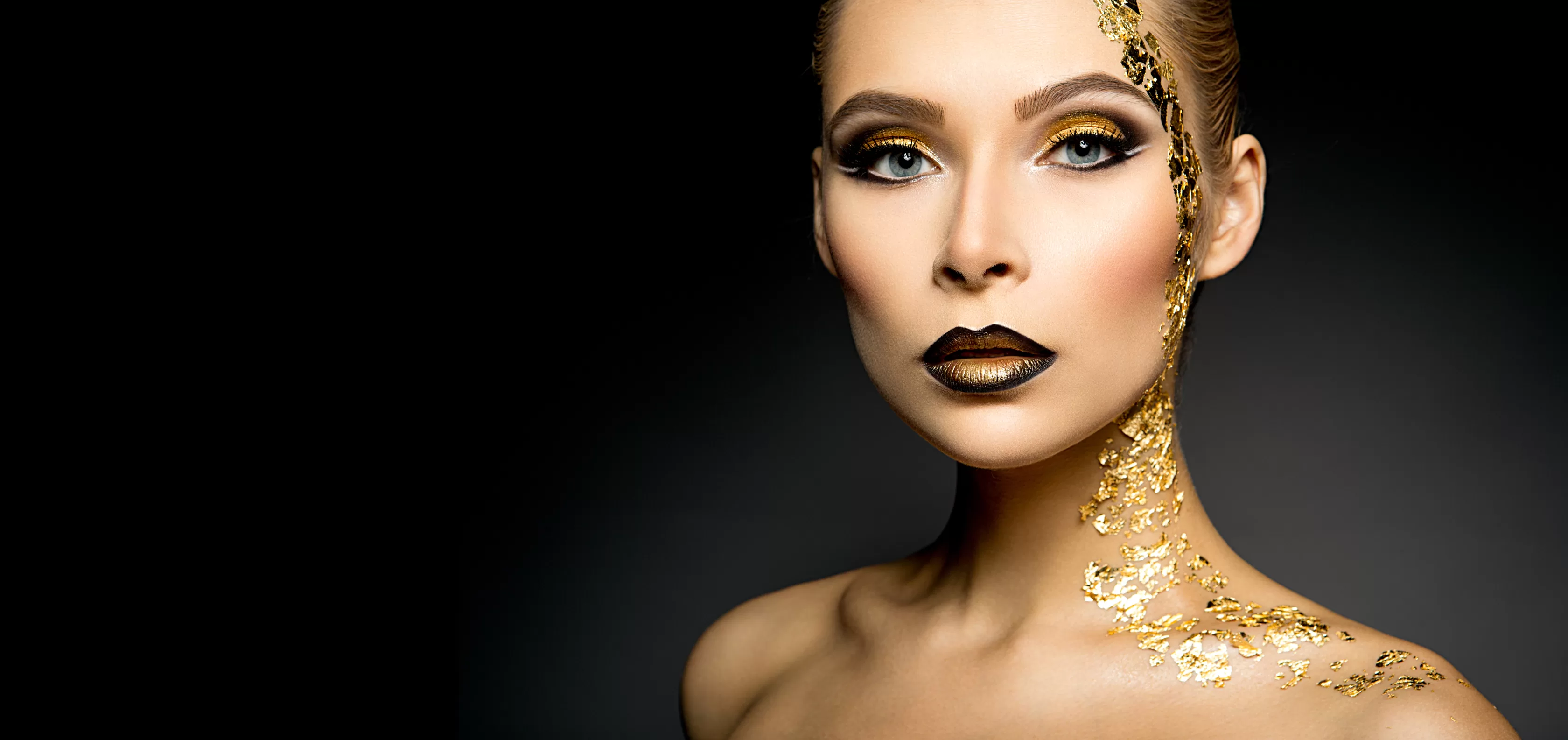 Beautyful girl with gold glitter on her face and body